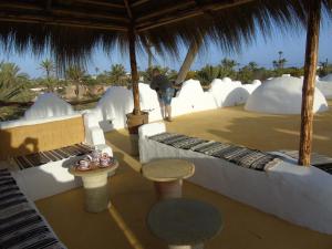 a person standing under an umbrella in a resort at Dar Aladin in Arkou