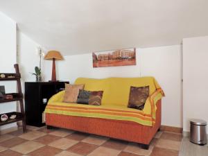 a yellow couch sitting in a living room at El Rincon de Isabel in Málaga