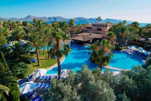 a beach scene with a large pool of water at PortBlue Club Pollentia Resort & Spa in Alcudia