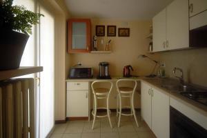 a kitchen with a counter and two stools at Bed and Breakfast Monterosa in Sesto Calende