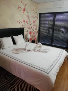 a bedroom with a large bed with towels on it at Sea and Marina view Apartment in Setúbal