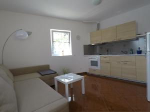 a living room with a couch and a table at Apartments Pegla in Nerezine