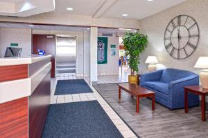 a living room with a blue couch and a table at Americas Best Value Inn & Suites Maryville in Maryville