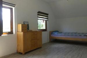 a bedroom with a bed and a dresser and a window at Una holiday house in Bihać