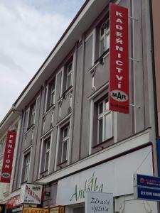 a building with signs on the side of it at Penzion MAR in Hradec Králové