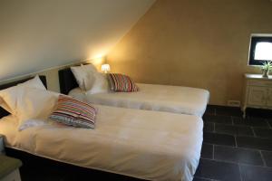 Letto o letti in una camera di Logies Tommenmolen