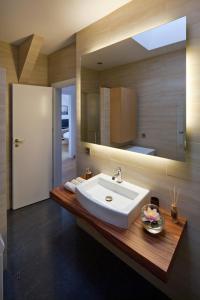 a bathroom with a sink and a mirror at Luxoise Apartments in Berlin