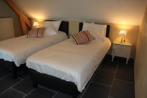 Letto o letti in una camera di Logies Tommenmolen