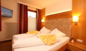 Postel nebo postele na pokoji v ubytování Aparthotel DAS Hochkönig