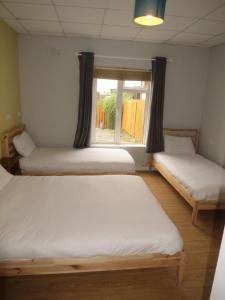 Postel nebo postele na pokoji v ubytování Rougey Lodge Hostel