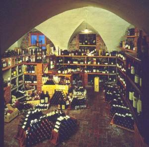 a room filled with lots of bottles of wine at Albergo della Torre dal 1891 in Trescore Balneario