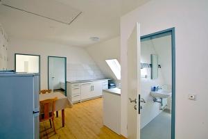 a large white kitchen with a sink and a mirror at FeWo`s Katharina in Bremerhaven +17 photos
