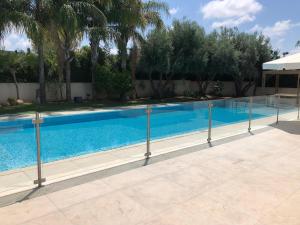 a swimming pool with a fence around it at Villa Alice Caesarea in Caesarea