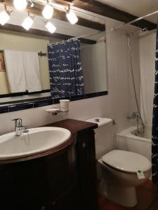 a bathroom with a sink and a toilet and a mirror at El torreón in Albarracín +20 photos