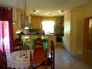 a kitchen with a table and some chairs and a table and a kitchen at Casa del Arte in L'Ametlla de Mar