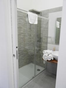 a glass shower in a bathroom with a sink at Mattandre in Monteroni di Lecce