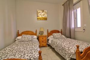 Posteľ alebo postele v izbe v ubytovaní Apartamentos Aloha2 El Puerto de Santa Maria