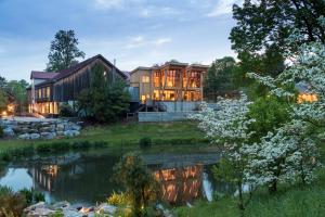 a house with a pond in front of it at Glasbern in Fogelsville