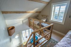 a bedroom with two bunk beds in a attic at Mini Apartment Sakrisøy in Reine
