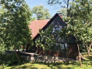 a home with a red roof and trees at KÉSA Faház in Balatonlelle
