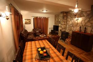 a living room with a table with fruit on it at Family Apartments in Žabljak