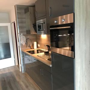 a kitchen with a black oven and a sink at Hahnenklee Ferienpark 1-411 in Hahnenklee-Bockswiese