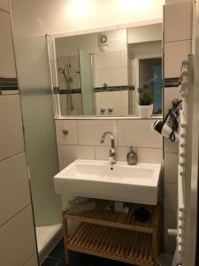 a bathroom with a sink and a mirror at Hahnenklee Ferienpark 1-411 in Hahnenklee-Bockswiese