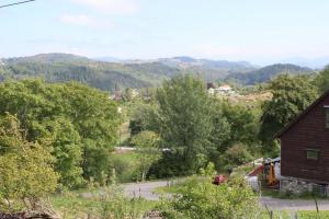 a view of a valley with a house and trees at Kartveit Gjestetun in Manger