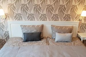 a bedroom with a bed with two pillows at Kraslava 2 Bedroom Lux Apartments in Krāslava