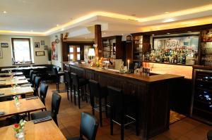 a bar in a restaurant with tables and chairs at Zum Scheffelhof in Maulbronn