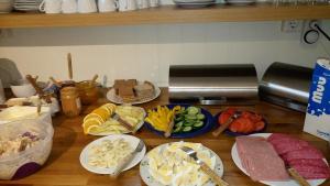 a table with plates of food on a counter at Guesthouse Hof in Hofgarðar