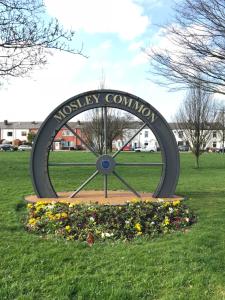 a large clock in the middle of a field at Mosley Common Road in Worsley