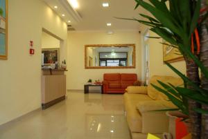 a living room with a couch and a mirror at Hotel Adriana in Bellaria-Igea Marina