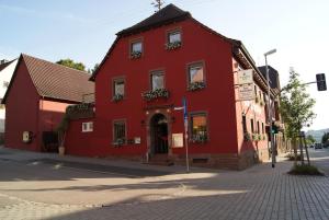 a red building on the corner of a street at Zum Scheffelhof in Maulbronn