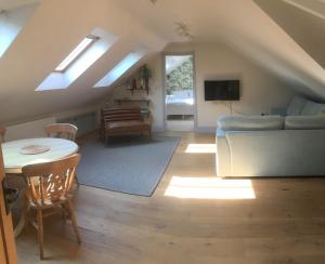 a living room with a couch and a table at The Old Winery Loft in Edale