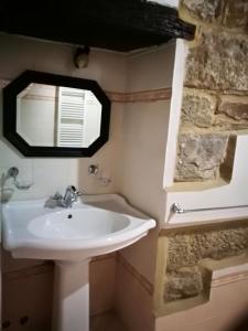 a bathroom with a sink and a mirror at Borgo dei Cavalieri in Cortona