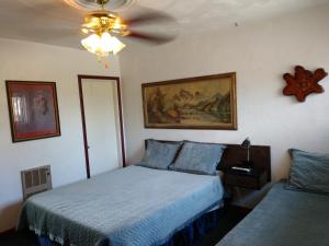 a bedroom with a bed and a ceiling fan at Swiss Mountain Motel in Thayne