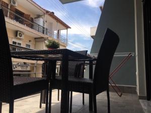 a table and chairs on the balcony of a building at Il Mondo Apartments in Stavros