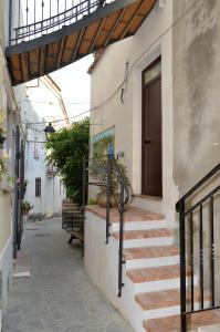 einen Flur eines Hauses mit Treppe und Tür in der Unterkunft Relax nel Centro Storico in San Nicola Arcella