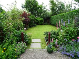 a garden with flowers and a path in the middle at The Garden Flat in Crieff