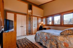 a bedroom with a bed and a flat screen tv at Aspen Ridge Condominiums by Keystone Resort in Keystone