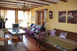 a living room with a couch and a table at Mirador de Enterrias in Enterria