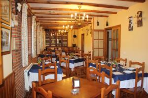 a dining room with wooden tables and chairs at Mirador de Enterrias in Enterria
