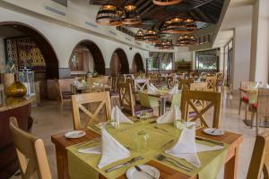 a dining room with tables and chairs at Royalton Splash Punta Cana, An Autograph Collection All-Inclusive Resort & Casino in Punta Cana