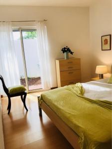 1 dormitorio con 1 cama, vestidor y ventana en A Casa Do Terraco en Ponta Delgada
