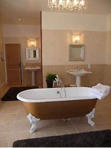 a large bathroom with a tub and a sink at Chateau d'Hordosse in Andiran