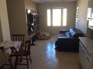 a living room with a couch and a table at Casa da Jussara in Itaperuna