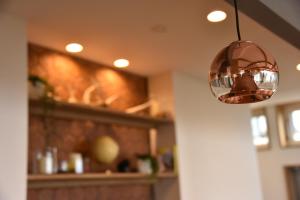 a glass light hanging from a ceiling in a room at Shiretokoserai in Rausu