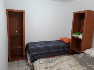 a small bedroom with a bed and a closet at Departamento ideal I! in Villa María