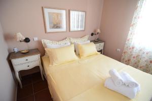 a small bedroom with a bed with towels on it at Villa Blue in Skala Potamias